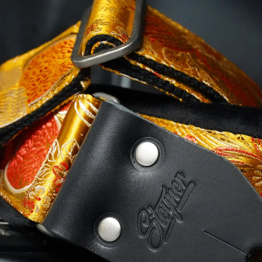 Gepolsterter Premium Gitarrengurt – Tropical Mango 70 mm (schwarz-silber)